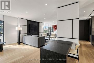 Toronto (Mount Pleasant West) condo for rent - A modern living room with a grey sofa and a black coffee table.