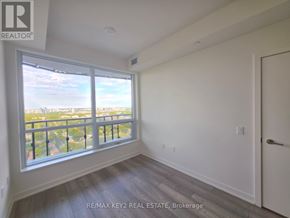 Toronto (Mount Pleasant West) condo for rent - A room with a large window overlooking a cityscape.