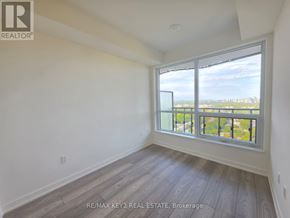 Toronto (Mount Pleasant West) condo for rent - A room with a large window overlooking a cityscape.