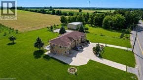 Hamilton apartment for rent - A large house with a brown roof is surrounded by a green lawn and trees.