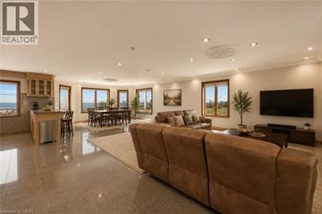 Hamilton apartment for rent - A spacious living room with a large couch and a television.