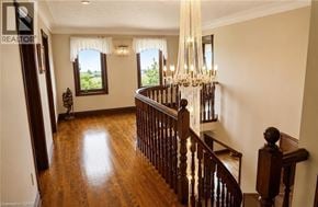 Hamilton apartment for rent - A chandelier hangs over a staircase in a home.