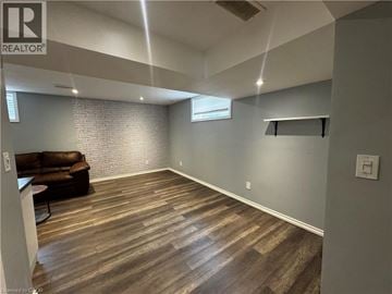Kitchener townhouse for rent - A living room with a couch and a wooden floor.