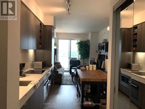 Toronto (Mount Pleasant West) condo for rent - A modern kitchen with a dining area in the background.