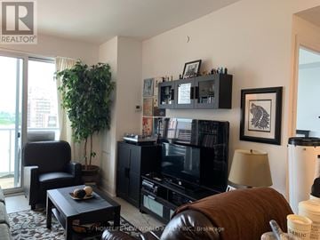 Toronto (Mount Pleasant West) condo for rent - A living room with a black leather couch and a flat screen TV.