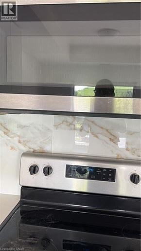 Kitchener townhouse for rent - A modern kitchen with a stove top oven and a marble backsplash.