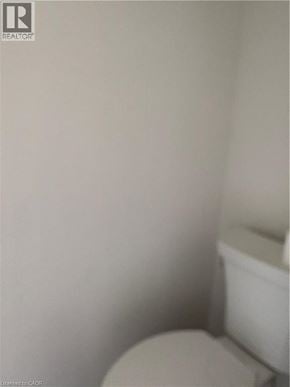 Kitchener townhouse for rent - A white toilet in a small bathroom.