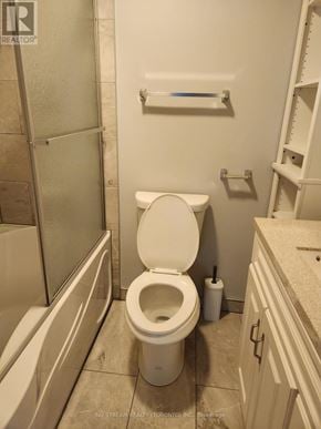 Niagara Falls (Clifton Hill) apartment for rent - A white toilet in a bathroom with a white cabinet and a white towel rack.