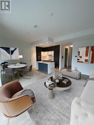 Toronto (Waterfront Communities) condo for rent - A modern living room with a brown leather chair and a white couch.