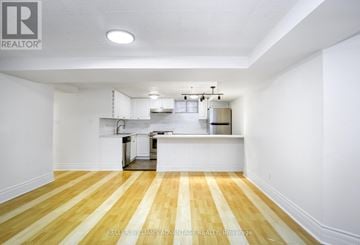 Toronto (Annex) apartment for rent - A kitchen with white cabinets and a wooden floor.