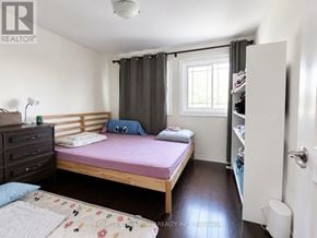 Markham (Middlefield) apartment for rent - A bedroom with a bed, dresser, and a window with curtains.