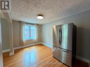 Brampton (Downtown Brampton) apartment for rent - A kitchen with a stainless steel refrigerator and wooden flooring.