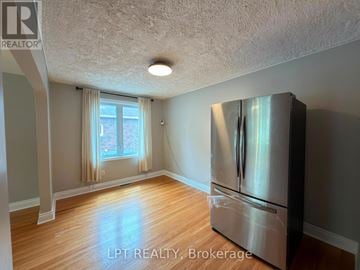Brampton (Downtown Brampton) apartment for rent - A kitchen with a stainless steel refrigerator and wooden flooring.
