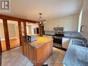 Brampton (Downtown Brampton) apartment for rent - A kitchen with a granite countertop and stainless steel appliances.
