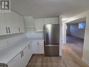 St. Catharines (Secord Woods) apartment for rent - A kitchen with white cabinets and a stainless steel refrigerator.