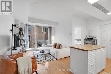 Ottawa condo for rent - A living room with a brown leather chair and a white couch.