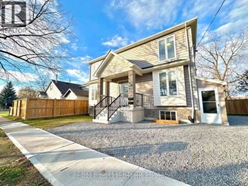 St. Catharines (Secord Woods) apartment for rent - A house with a gravel driveway and a wooden fence in the background.