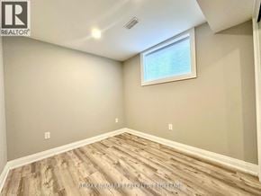 St. Catharines (Secord Woods) apartment for rent - A room with a window and wooden flooring.