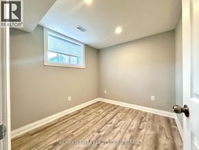 St. Catharines (Secord Woods) apartment for rent - A room with a window and wooden flooring.