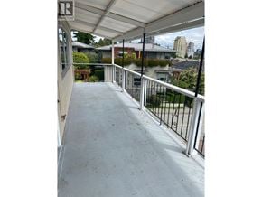 West Vancouver apartment for rent - A balcony with a metal railing and a white wall.