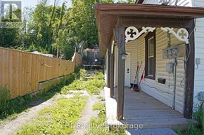 South Bruce Peninsula duplex for rent - A wooden fence and a porch with a cross design on it.