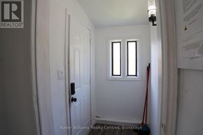 South Bruce Peninsula duplex for rent - A white door with a black handle and a window above it.