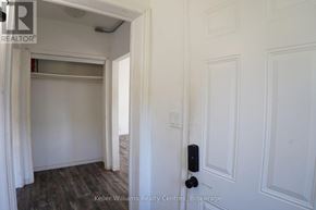 South Bruce Peninsula multi-family for rent - A white door with a black handle is in a room with white walls.