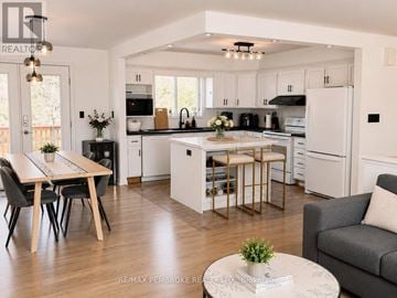 Petawawa apartment for rent - A modern kitchen with a dining table and chairs.