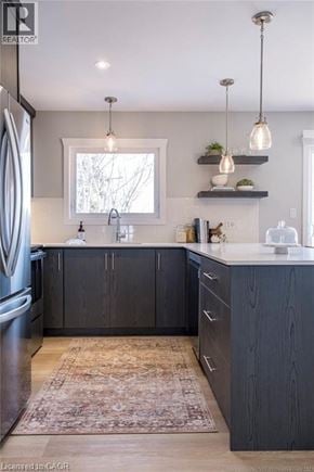 Hamilton apartment for rent - A kitchen with dark wood cabinets and a rug on the floor.