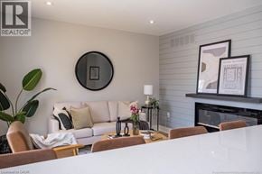 Hamilton apartment for rent - A living room with a white couch, a coffee table, and a fireplace.