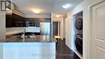 Toronto (Islington-City Centre West) condo for rent - A kitchen with a refrigerator, microwave, and dishwasher.