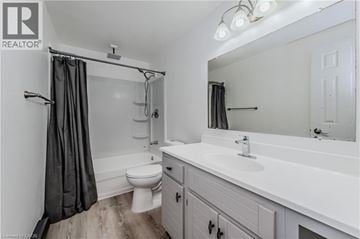 Cambridge townhouse for rent - A white bathroom with a toilet, sink, and shower.