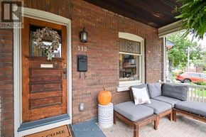 Toronto (The Beaches) apartment for rent - A house number 118 with a door and a sofa on the porch.