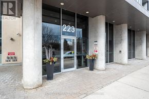Mississauga (City Centre) condo for rent - The image shows the front of a realtor's office with the number 223 on the glass door.