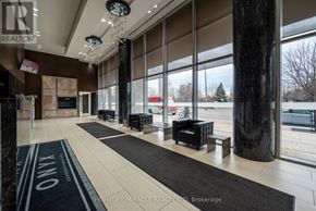 Mississauga (City Centre) condo for rent - A lobby with a black and white carpet and a glass wall.