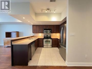 Burlington (Brant) townhouse for rent - A kitchen with dark brown cabinets and stainless steel appliances.