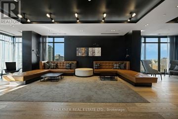Ottawa condo for rent - A modern living room with a large sectional sofa and a rug.