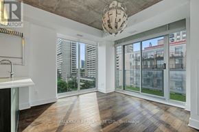 Ottawa condo for rent - A well-lit, spacious room with a view of the cityscape through large windows.