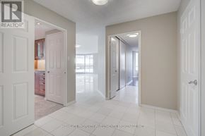 Toronto (Kensington-Chinatown) condo for rent - A spacious room with white doors and a tiled floor.