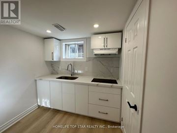 Richmond Hill (Crosby) duplex for rent - A white kitchen with a sink and cabinets.