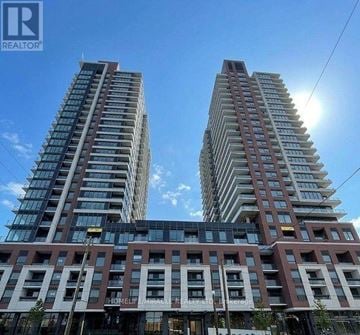 Toronto (Humber Heights) condo for rent - Two tall residential buildings with balconies and a sign that reads "HOMELIFE MIRACLE".