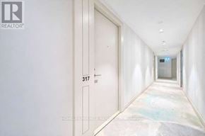 Toronto (Humber Heights) condo for rent - A long hallway with a door marked 317 on the wall.