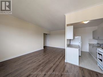 Toronto (Parkwoods-Donalda) condo for rent - A room with wooden flooring and a kitchenette in the corner.