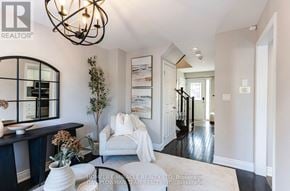 Whitby (Pringle Creek) apartment for rent - A living room with a white sofa and a chandelier.