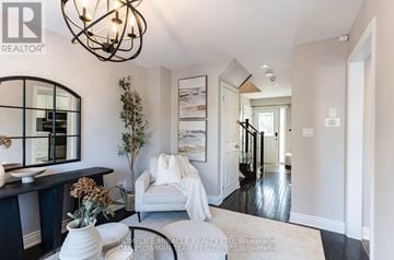 Whitby (Pringle Creek) apartment for rent - A living room with a white sofa and a chandelier.