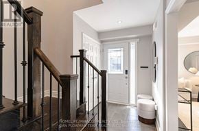 Whitby (Pringle Creek) apartment for rent - A hallway with a wooden staircase and a white door.