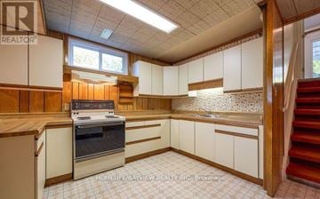 Markham (Royal Orchard) apartment for rent - A kitchen with white cabinets and a stove top oven.
