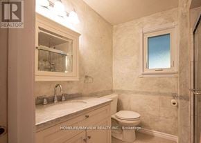 Markham (Royal Orchard) apartment for rent - A bathroom with a toilet, sink, and mirror.