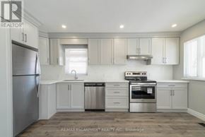 Hamilton (Westcliffe) apartment for rent - A kitchen with white cabinets and stainless steel appliances.