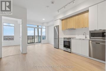 Vaughan (Brownridge) condo for rent - A spacious kitchen with white cabinets and stainless steel appliances.